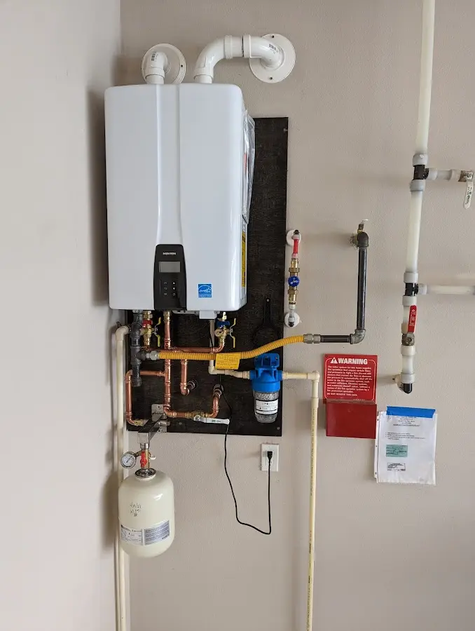 Professional plumber installing copper piping in a Mililani Town home